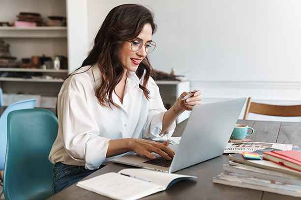 Femme devant ordinateur suit un webinaire
